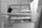 Blurred factory worker carrying long box