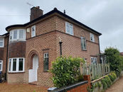 a large semi detached home on a cloudy day