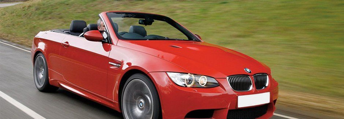 man driving red convertible BMW