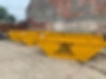three yellow skips