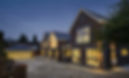 grand detached property lit up at night