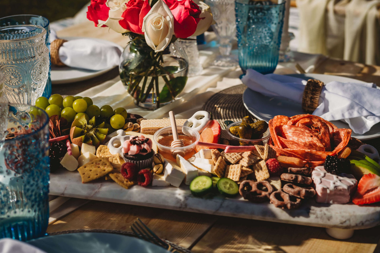 Close-up of the Babe in Blue picnic setup with decor and delicious goodies by Sunkissed Design & Co.