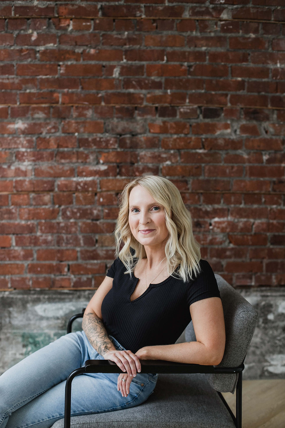 Brynn, founder of BL Marketing, sitting in studio