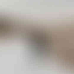 Romantic winter scene with a couple standing in a snow-covered path, man lifting woman off the ground in an embrace.