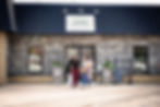 Exterior of Dutchess Flower Company in Lacombe with brick façade and customers walking out