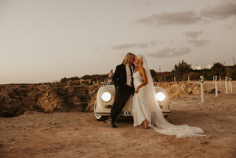 Couple just married in Greece, sharing an intimate moment. 