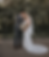 Happy couple hugging in a scenic field after finding wedding attire at Your Wedding Place