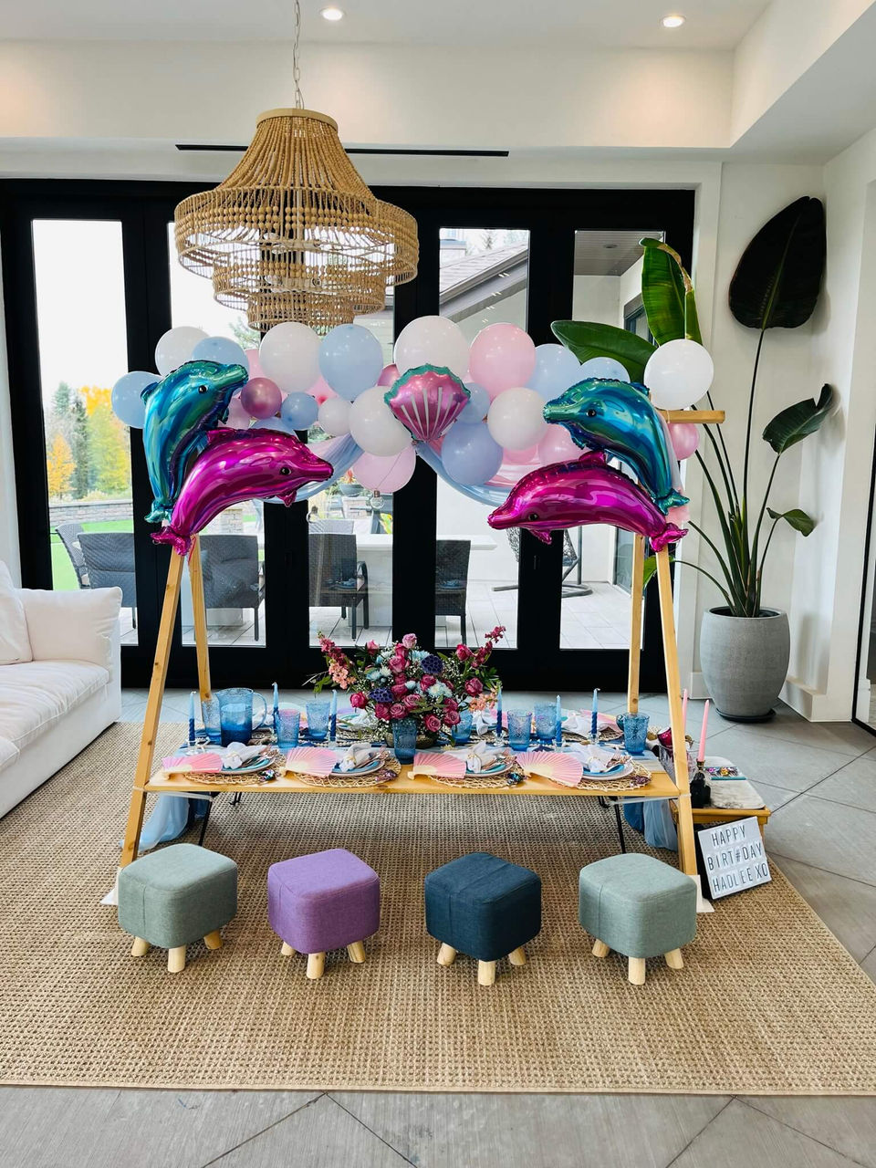 Picnic table setup with dolphin and mermaid-themed decor by Sunkissed Design & Co.