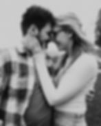 Joyful couple sharing a playful moment, with a tender embrace and smiles in a casual setting.