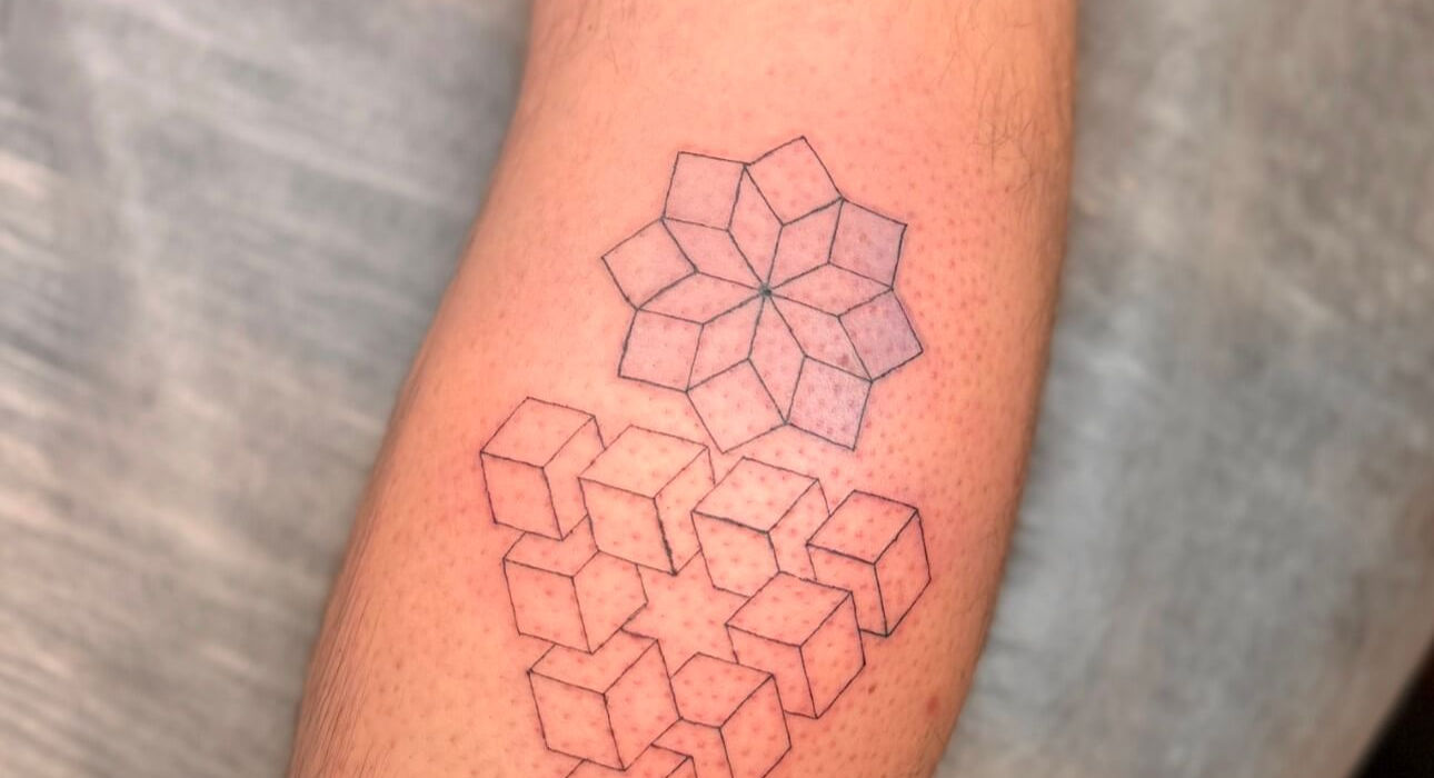 Geometric cube tattoo with layered cube patterns and fine line details on the leg, offering a modern style.