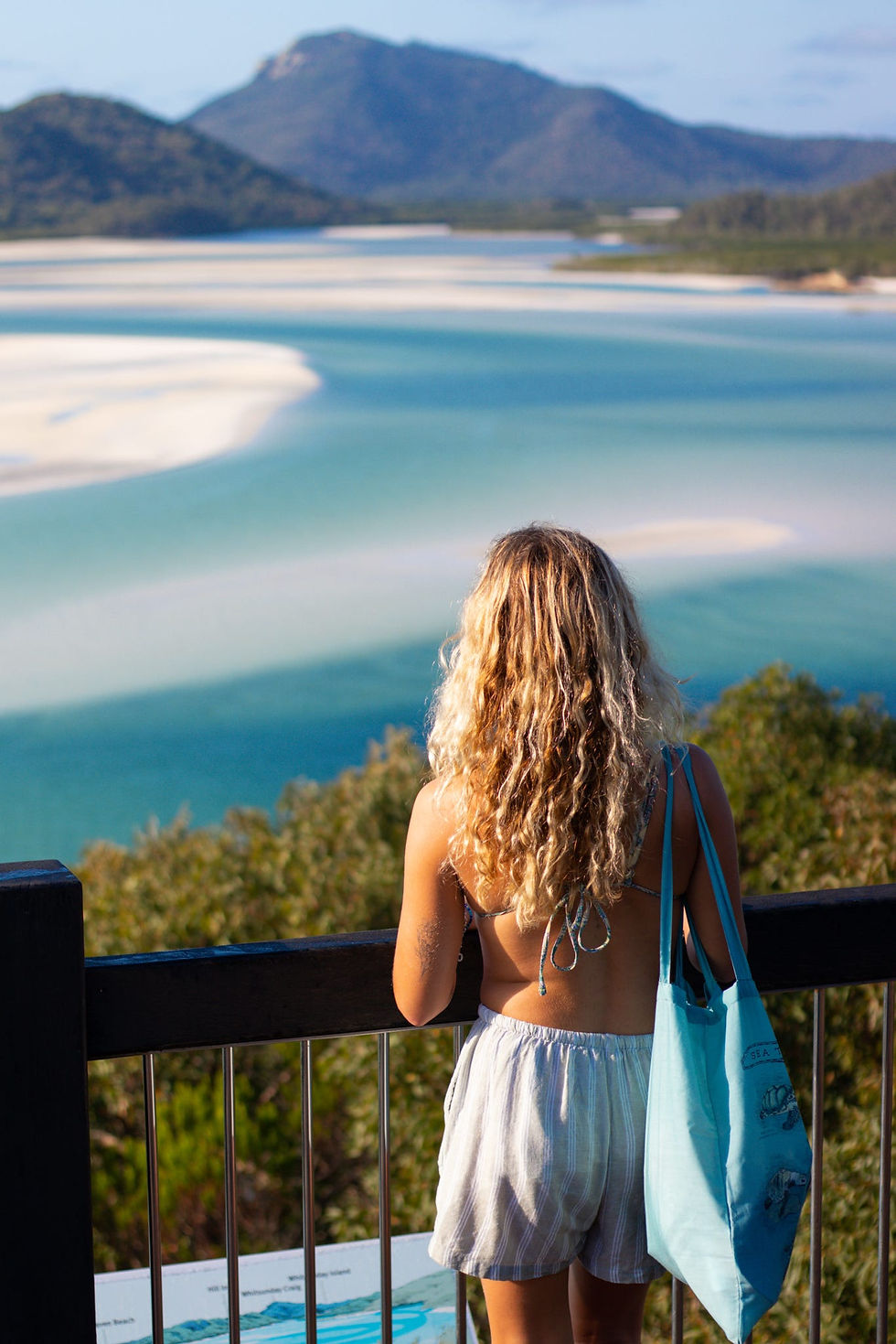 Girl looking out athe famouse Hill Inlet Lookout in te Whitsundays