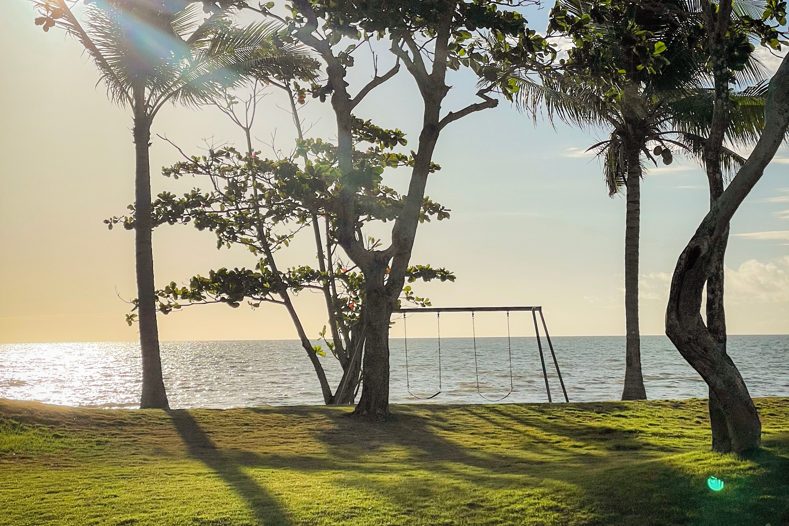 Beachfront swing at Solmera Beach Park Resort at sunset.