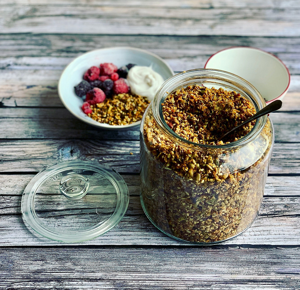 Claudine's healthy homemade granola includes pumpkin seeds, sunflower seeds, desiccated coconut, linseed and pecan nuts and is served with coconut yoghurt, kefir yoghurt, greek yoghurt and frozen raspberries