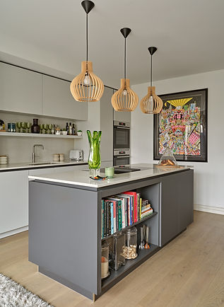 Kitchen island with integrated storage and statement wooden pendant lighting in a luxury home