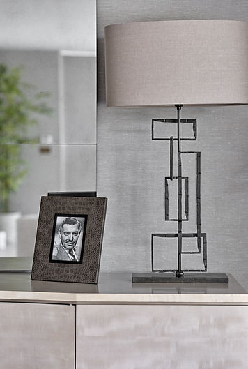 Table lamp and styled console with layered textures creating a sophisticated interior vignette