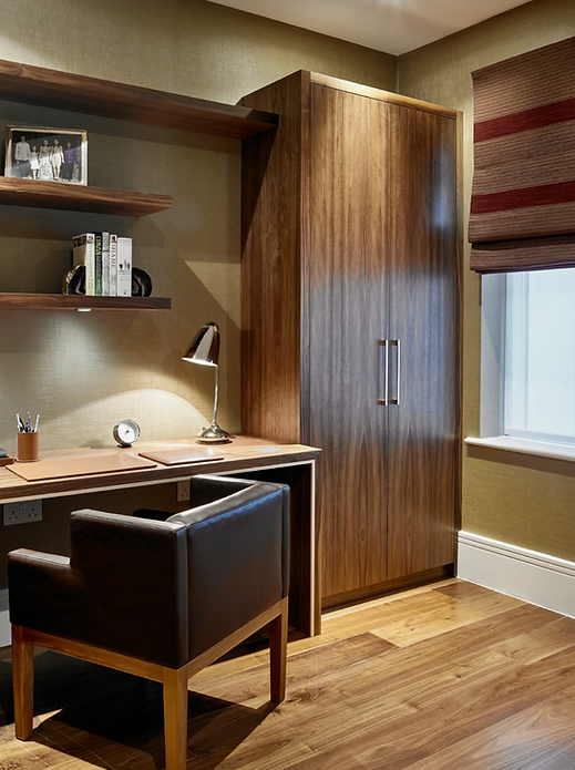 Bespoke home office with walnut desk, shelving and integrated wardrobe storage