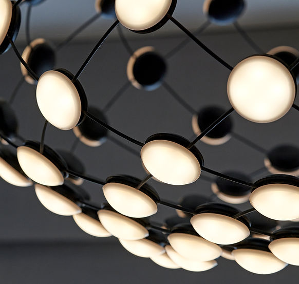 Contemporary lighting design featuring sculptural pendant lighting and layered architectural illumination in a luxury interior