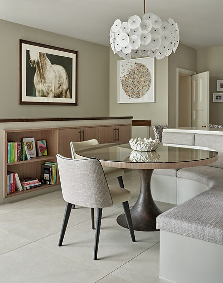 Dining area with statement chandelier, bespoke joinery and contemporary furniture design