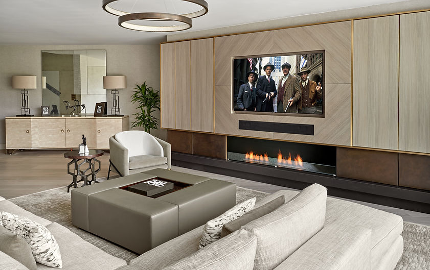 Bespoke media wall with integrated fireplace and cabinetry in a luxury living room