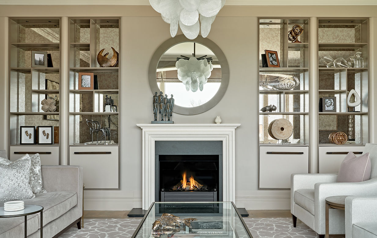 Symmetrical living room with bespoke cabinetry, fireplace and curated accessories creating a balanced focal point