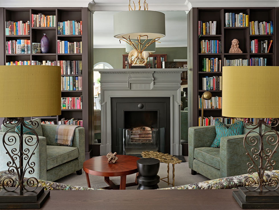 Traditional living room with fireplace, built-in bookcases and layered lighting, luxury interior design