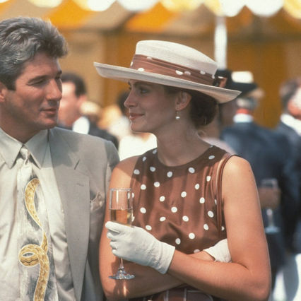 A stunning ruby and diamond necklace, famously worn by Vivian in Pretty Woman, featuring pear-shaped rubies encased in dazzling white diamonds.