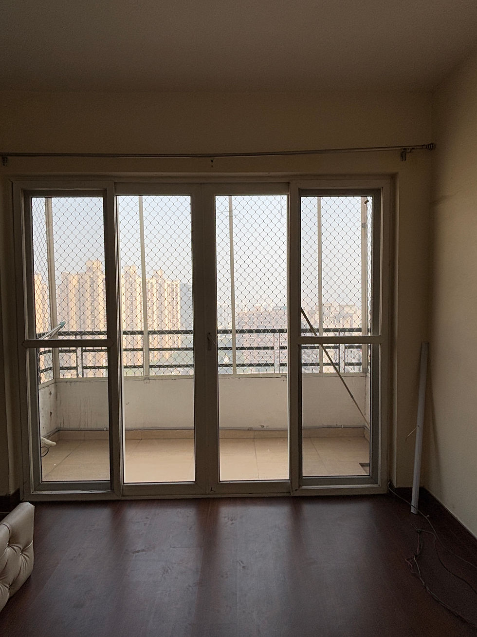 Before: The original apartment had darker finishes and visually heavy surfaces that made the interiors feel compact.