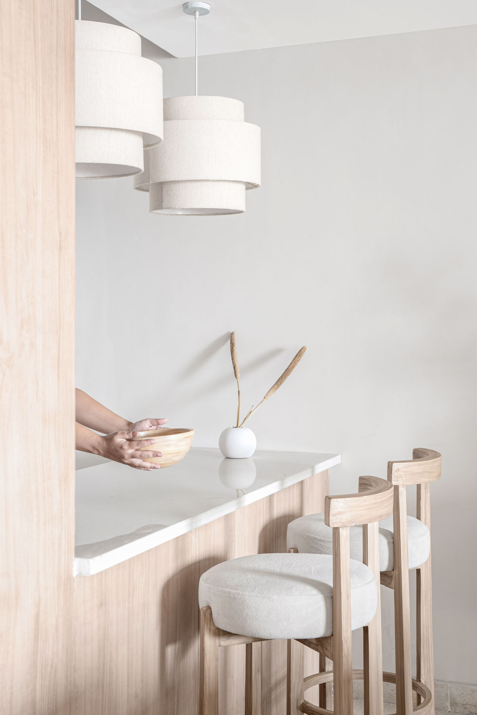 Minimalist kitchen with white decor and wooden accents.