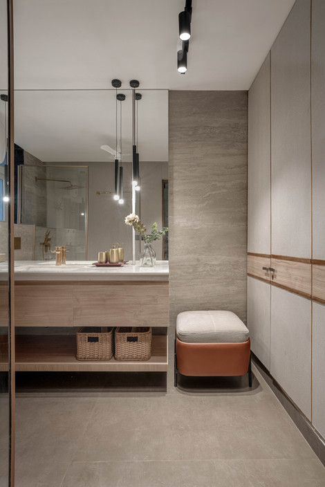 Modern bathroom with elegant lighting and storage baskets.