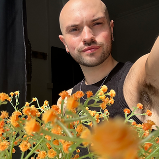 A Selfie of Jordan in front of Yellow Flowers