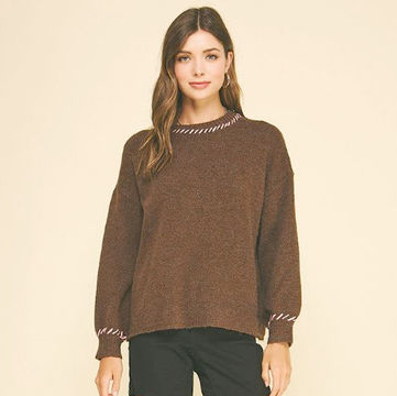 with pink whipstitch detail on neckline and cuffs