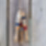 decorative painted wood fish on twine string with wood slat background