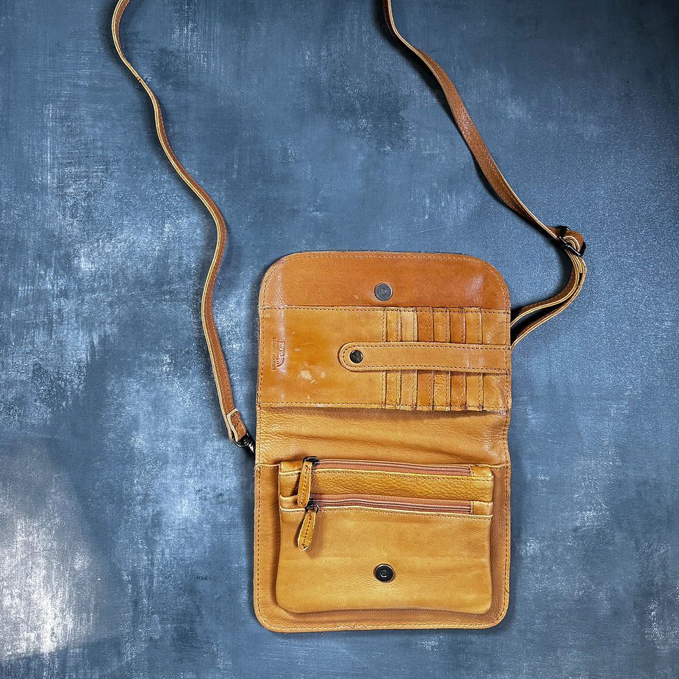 interior of crossbody purse in cognac color with slate background