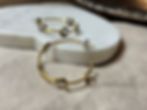 Smokey Quartz Hoops laying on marble and linen