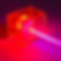 A beam of purple light passes through a transparent red cube on a dark background, creating a futuristic and dynamic visual effect.