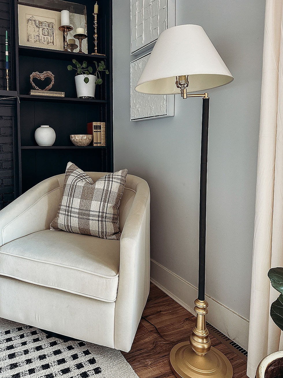 family room, black fireplace, white velvet barrel chair , black and white checkered wool area rug, floor lamp, thrifted, cream velvet curtains, diy textured wall art, shelf ctyling, vintage thrifted decor, plaid pillow cover, black and gold swing arm floor lamp, the rural legend