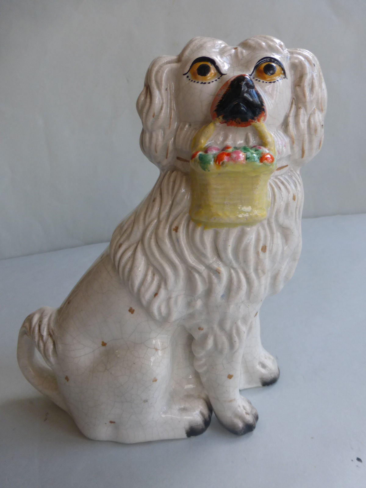 Single 19thc. Staffordshire Lion Dog with basket of flowers. Ref # 4650