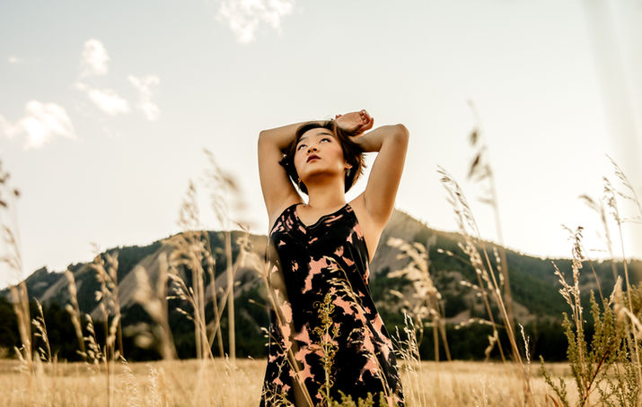 A woman poses stylishly in front of the flat irons.