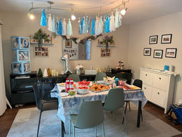 A dining room is set up with first birthday edcor.