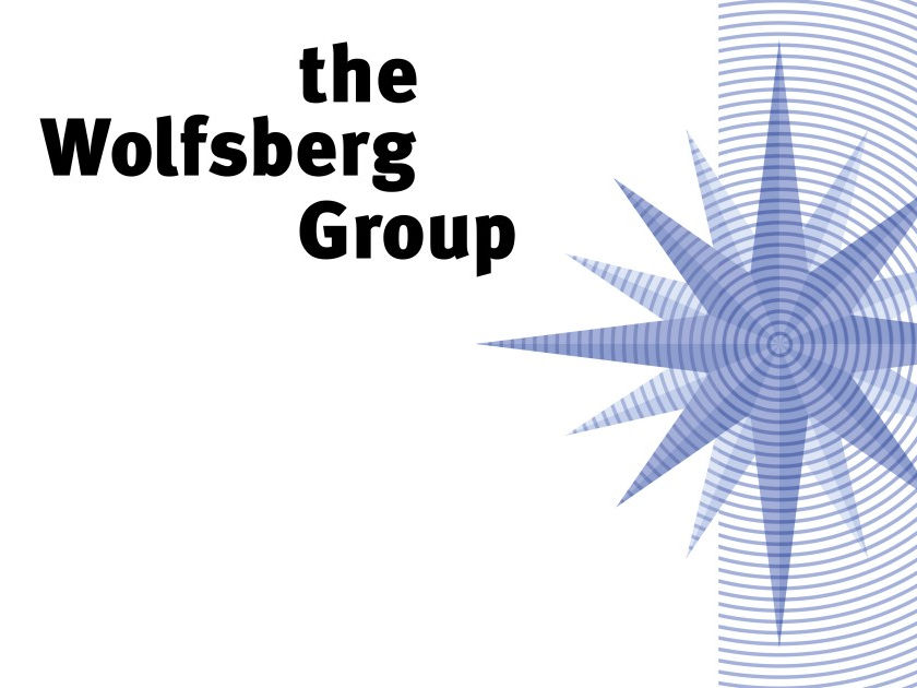 Text "the Wolfsberg Group" in bold black font on a white background with a blue starburst pattern on the right.