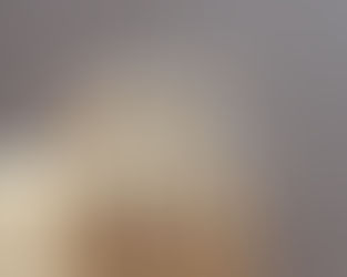 Three wooden mannequins sit on a box with heads bowed, conveying melancholy. Neutral background, soft lighting.