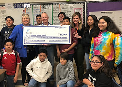 Several middle school children at a donation presentation