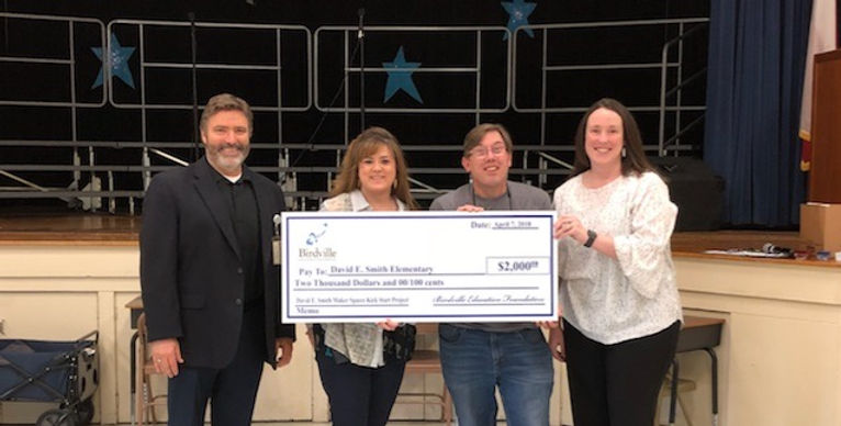Members of the Birdville Education foundation present a donation check