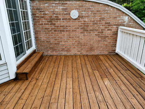 Completed deck staining using Cabot Australian Timber Oil on a wooden deck beside a brick home in Kitchener-Waterloo — by Enviro Painting