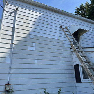 power washing on siding in progress