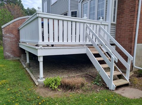 Newly stained white deck with stairs and railings on a brick home in Kitchener-Waterloo — completed by Enviro Painting