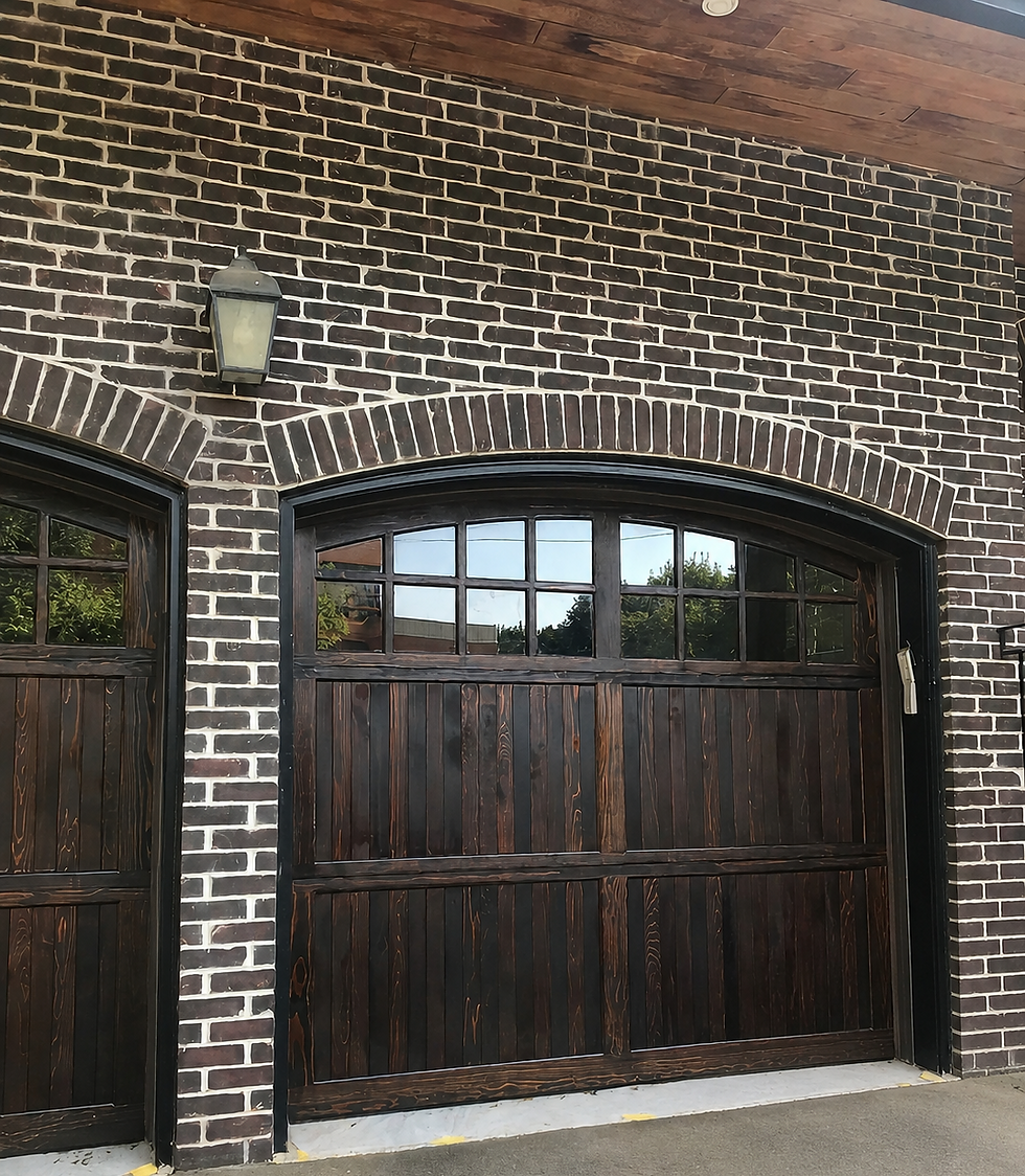 Close-up of freshly stained garage door panel showing rich dark wood tone
