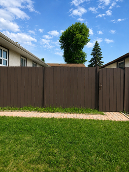 Dark stained wooden privacy fence on a residential property in Kitchener-Waterloo — fence staining by Enviro Painting