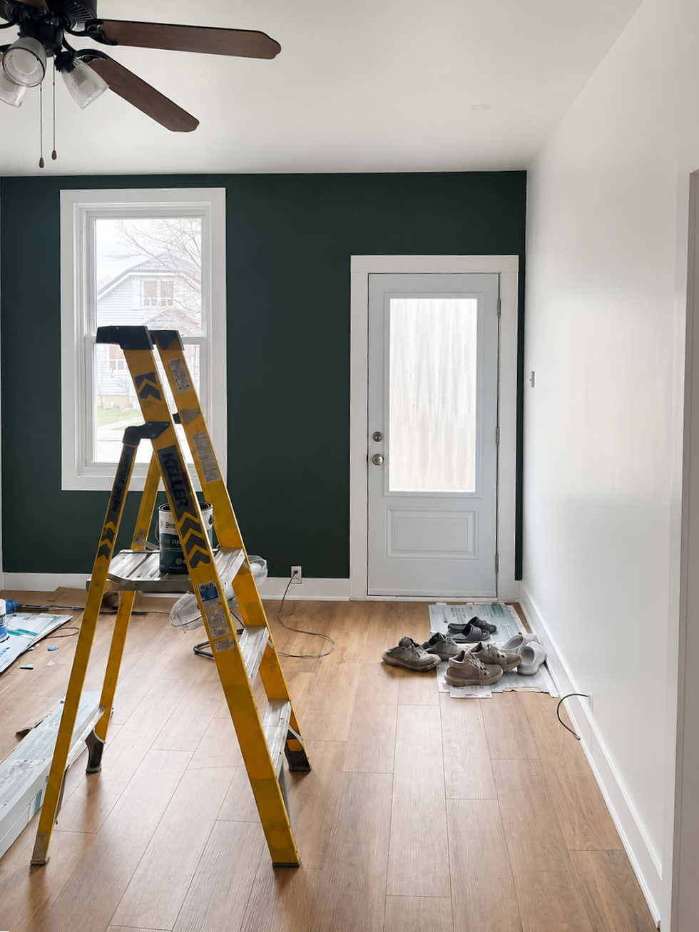 a painted interior entryway of a home in Woodstock Ontario, featuring a dark blue-green accent wall