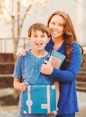 Logodentity Designer Ashley Shelton and her son with the brand parcel and passport